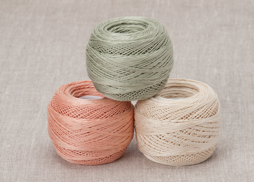 Thread Spools On Natural Linen Background